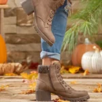 A collection of trendy fall shoes displayed in an autumn-inspired outdoor setting.