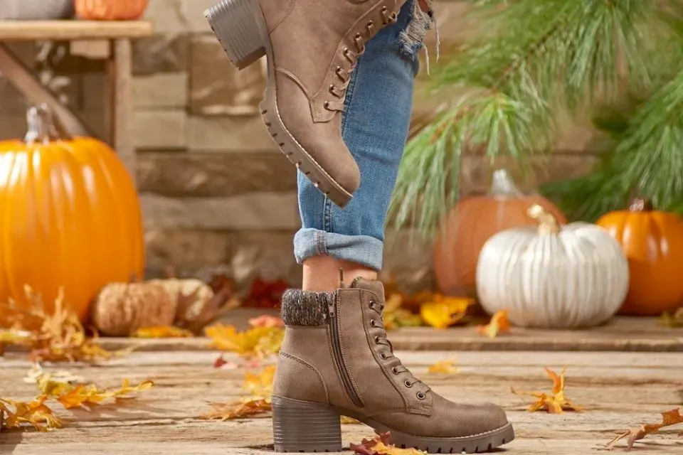 A collection of trendy fall shoes displayed in an autumn-inspired outdoor setting.